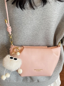 Pink PU leather crossbody bag with cute plush pendant and adjustable gold strap hardware