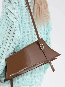 Brown patent leather shoulder bag with adjustable strap and stylish geometric shape