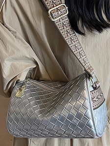 Silver woven pillow shoulder bag with ethnic patterned wide strap and gold hardware