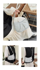 Détail du sac à bandoulière plissé gris clair avec chaîne en métal décorative en cœur