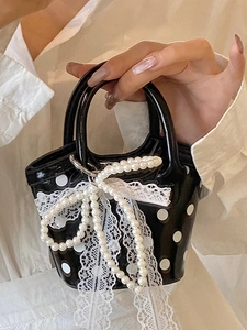 Mini black polka dot tote bag with white lace trim and pearl bow charm for summer