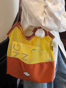 Contrast mesh tote bag with vibrant yellow mesh and orange canvas featuring a puppy design