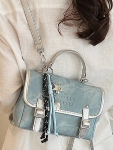 Light blue denim texture backpack with silver trim and metallic star moon charms