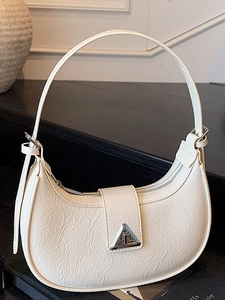 White pleated hobo shoulder bag with triangle metal buckle in a vintage crescent shape