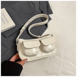 Close-up of cream-colored faux leather underarm bag with stylish double front pockets