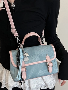 Blue denim and pink leather women's backpack with metallic buckle and star pendant accessory