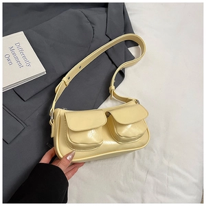 Detail of light yellow PU leather underarm bag with double front flap pockets and long strap