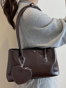 Dark brown glossy leather shoulder bag for women with a detachable heart charm accessory