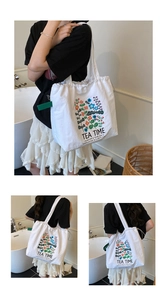 Detail of white canvas tote bag with floral print and drawstring closure design