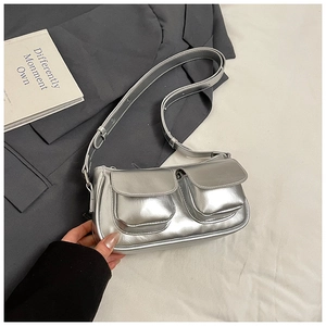 Detail of silver Y2K metallic shoulder bag with two front pockets and adjustable strap