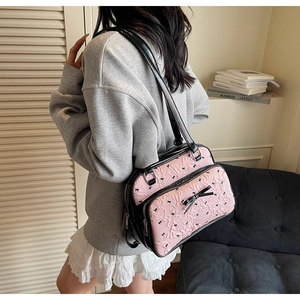 Pink bow-patterned backpack styled with casual outfit in a minimalist home setting