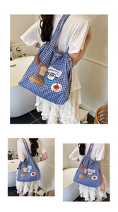 Detail of blue plaid tote bag with embroidery and functional drawstring closure