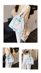 Detail of light blue drawstring tote bag with cartoon bear pattern and soft texture