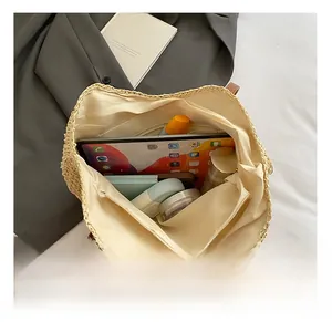 Macro view of large capacity straw tote bag interior showing space for tablet and makeup