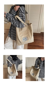 Detail view of beige canvas tote bag with unique double-layer pockets and blue text print