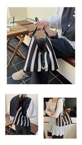 Close-up of black and white striped hollow-out mesh fabric with woven texture and hobo design