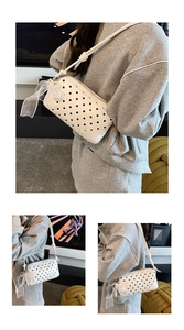 Detail of white polka dot baguette bag featuring elegant organza bow and pearl charm