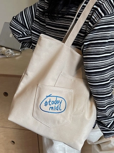 Minimalist beige canvas tote bag with blue #today midi embroidery and side pockets