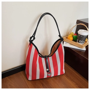 Detailed macro view of red and white striped mesh tote with black leather straps