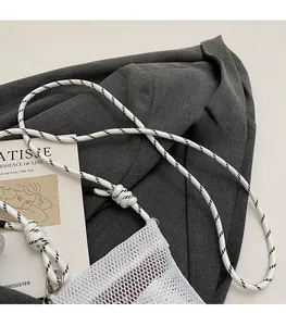 Close-up of lightweight white mesh phone bag featuring a stylish woven shoulder strap detail