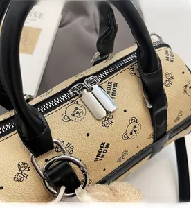 Detailed close-up showing smooth dual metal zippers on a beige lychee leather pillow bag