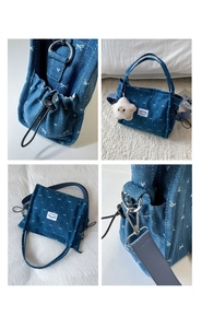 Detail view of denim tote bag with bow prints, star charm, and adjustable strap