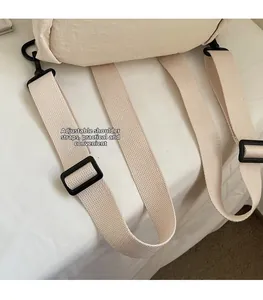 Detail of adjustable beige canvas shoulder strap with high-quality plastic buckle