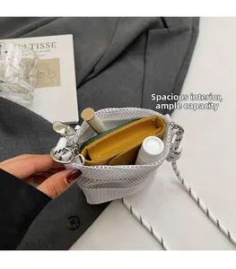 Detail view of white mesh crossbody bag showing spacious interior with drawstring closure