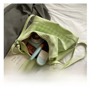 Interior view showing the large capacity of the green patchwork shoulder bag with daily items