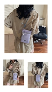 Detail of purple mesh crossbody phone bag with woven strap and heart charm