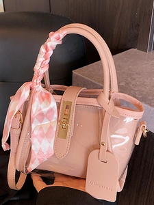 Pink transparent PVC bucket bag with silk scarf handle and adjustable shoulder strap