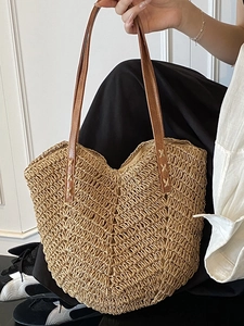 Large woven straw tote bag with brown leather handles for beach vacation shoulder carry