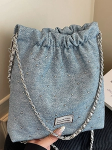 Chic light blue denim bucket bag with silver stud quilting and metal chain strap