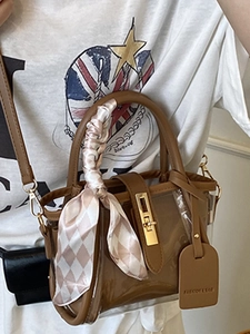 Brown translucent PVC bucket bag with silk scarf handle and gold turn-lock closure