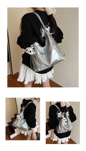 Detail of silver metallic tote bag with cracked texture and a cute panda plush charm