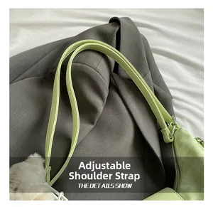 Detail showing mint green crossbody bag with adjustable shoulder strap and silver hardware