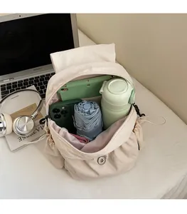Top view of large interior storage for tablet, phone, umbrella in beige canvas backpack