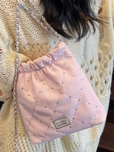 Chic pink quilted bucket bag with silver studs and elegant chain strap for women