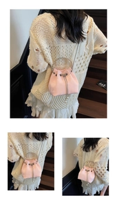 Detail view of pink velvet bucket bag with pearl pendant and transparent handle