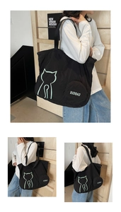 Macro view of black nylon tote bag featuring green cat print and round mini pouch