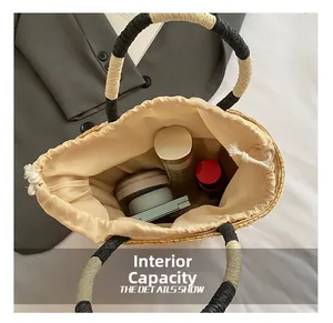 Detail view of woven straw bucket bag with drawstring closure showing internal capacity