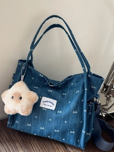 Blue denim tote bag with white bow pattern, star charm and adjustable shoulder strap