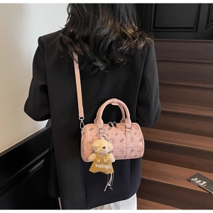 Pink cylinder bag featuring cute bear prints and a plush teddy bear charm detail
