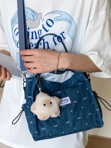 Cute dark blue denim crossbody tote bag with white bow patterns and star plush charm