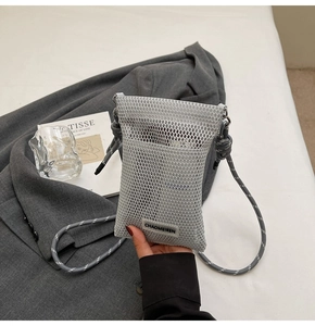 Detail of grey mesh crossbody phone bag with woven strap and small brand label