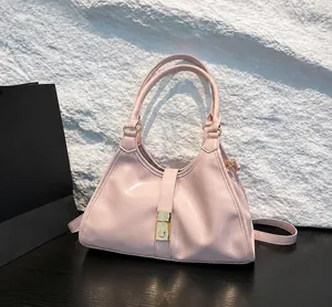 Elegant pink faux leather underarm handbag with a glossy finish and gold hardware.