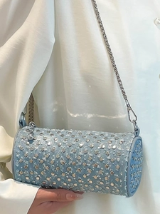 Light blue cylinder crossbody bag with silver studs and sequins on metallic chain strap