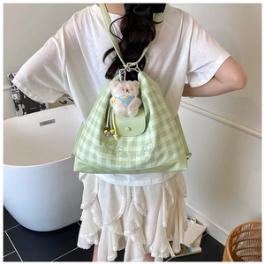 Detail of light green checkerboard canvas bag with Luckygirl embroidery and bear charm