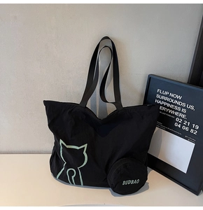 Large black tote bag with green cat line art and matching mini round coin purse