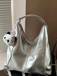 Large silver tote bag with metallic texture, contrast stitching and panda charm
